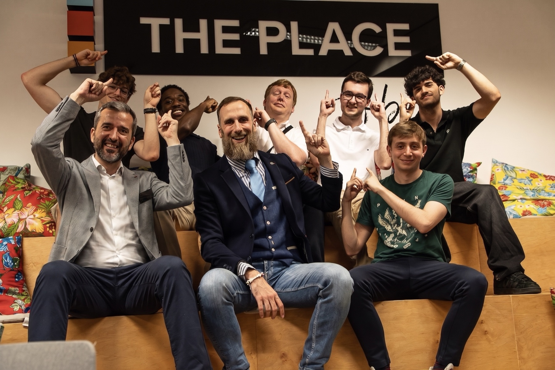 The full Dotika team, fingers pointing up